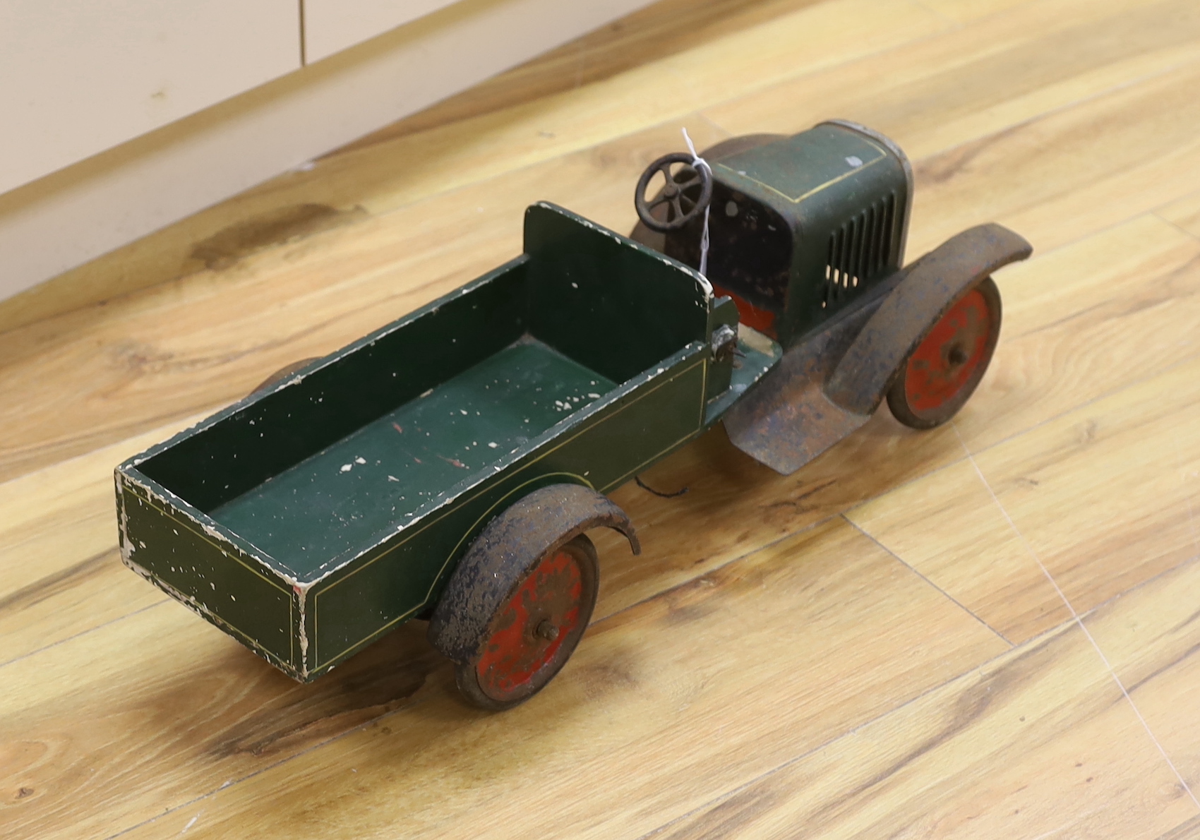 A large 1920s style tinplate and wood truck, length 62.5cm